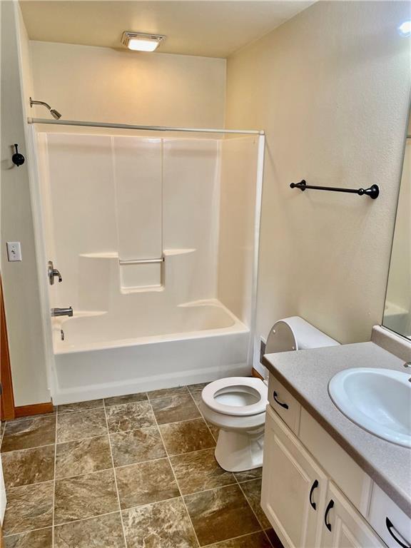 full bath with vanity, toilet, bathtub / shower combination, and visible vents