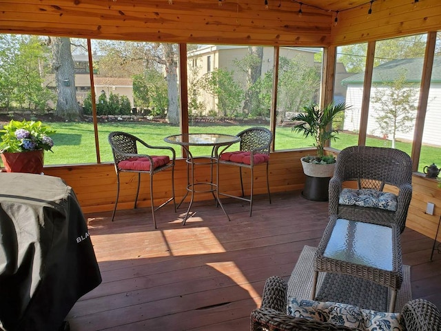 sunroom / solarium with lofted ceiling and a healthy amount of sunlight