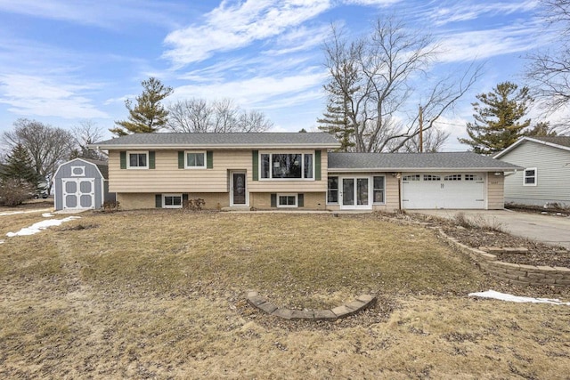 split foyer home with concrete driveway, an outdoor structure, an attached garage, and a shed