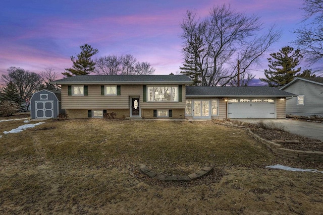 view of front of property with an outdoor structure, a storage unit, driveway, and an attached garage