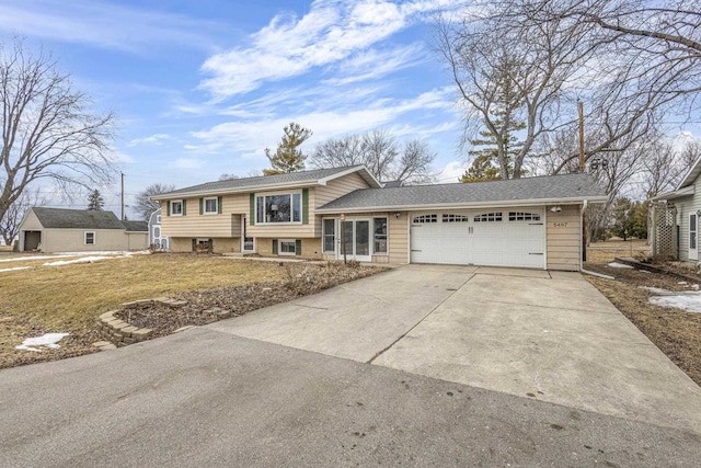 split level home featuring a garage, brick siding, and concrete driveway