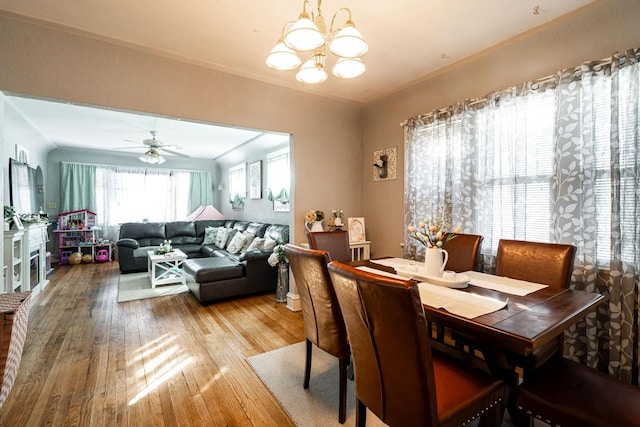 dining area featuring ornamental molding, ceiling fan with notable chandelier, and hardwood / wood-style floors