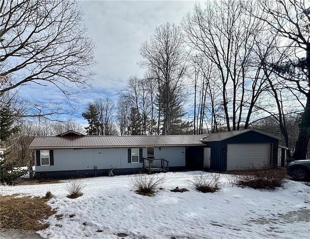 view of front of house with crawl space, metal roof, and an attached garage