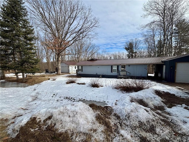 view of front of property featuring an attached garage and metal roof