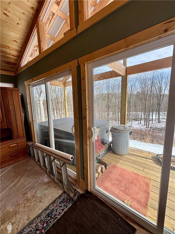 entryway featuring vaulted ceiling and wooden ceiling