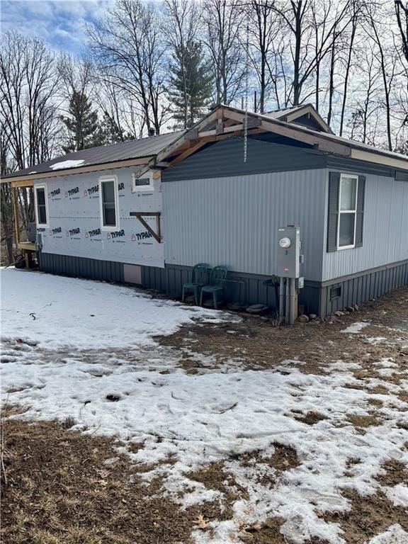 view of snow covered exterior with crawl space