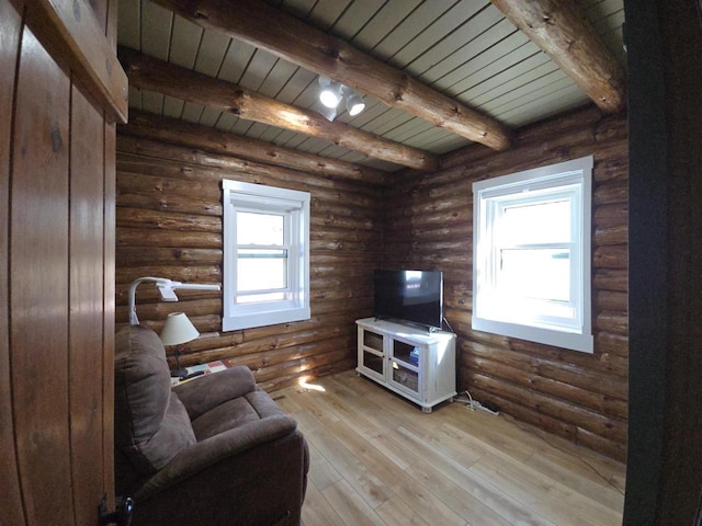 living room featuring log walls, beam ceiling, hardwood / wood-style floors, and wooden ceiling