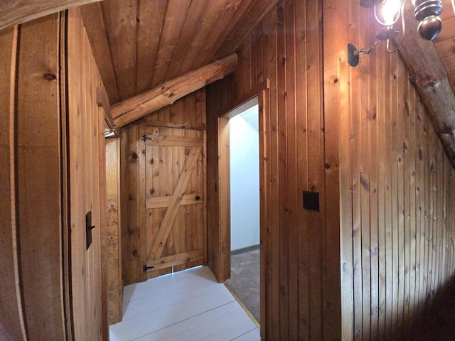 corridor featuring wooden walls