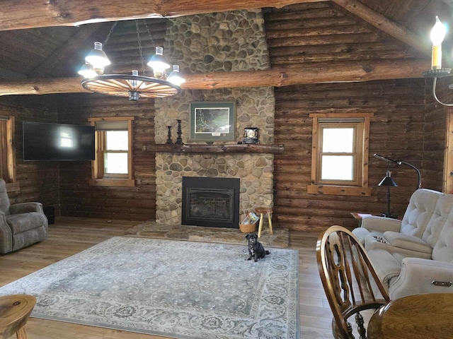 living room featuring wood finished floors, a wealth of natural light, and log walls