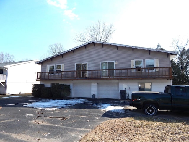 back of property with driveway and an attached garage