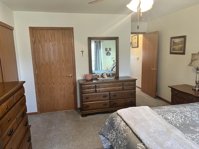 bedroom featuring baseboards and light colored carpet