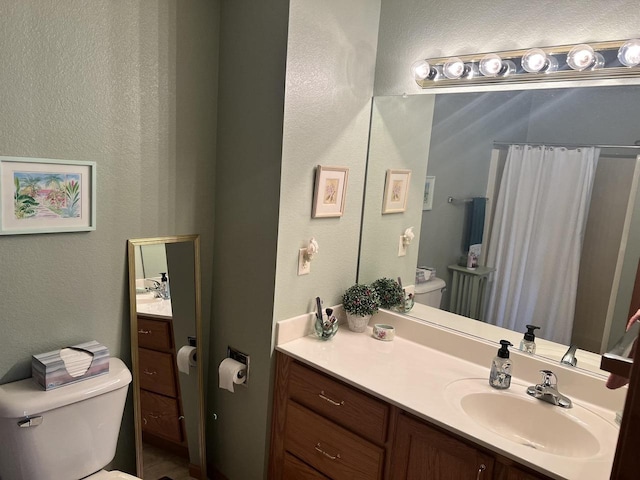 bathroom featuring curtained shower, toilet, vanity, and a textured wall