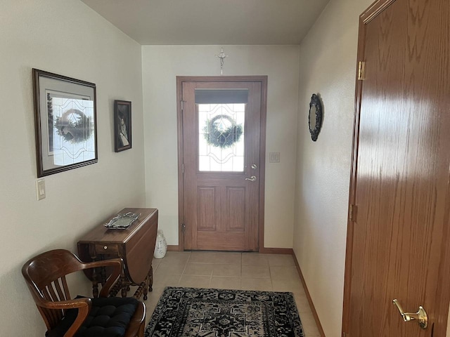 doorway to outside featuring light tile patterned floors and baseboards