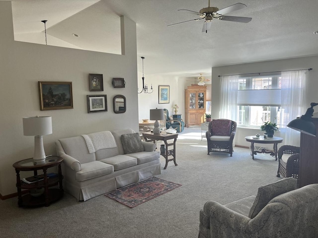 living room featuring carpet flooring, baseboards, lofted ceiling, and a ceiling fan