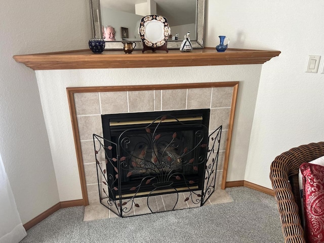 room details with a tiled fireplace, baseboards, and carpet floors