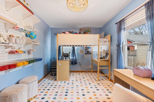 bedroom featuring carpet and baseboards