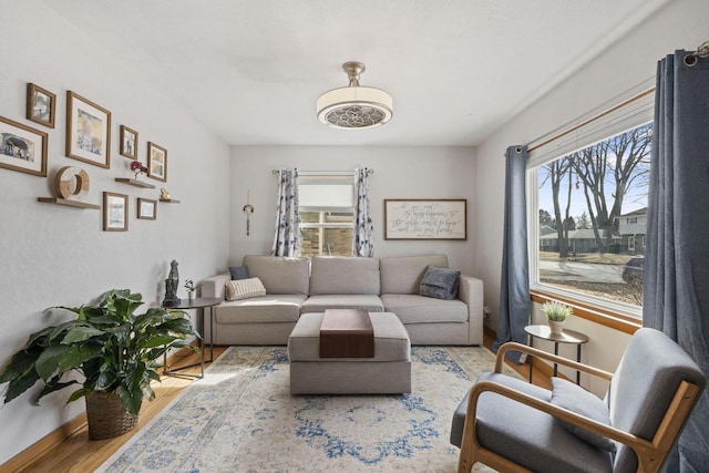 living area featuring baseboards and wood finished floors