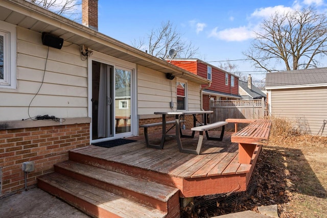 wooden deck with outdoor dining space and fence