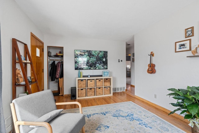 living room with wood finished floors and visible vents