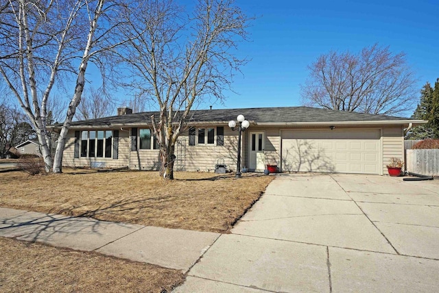 single story home with an attached garage, a chimney, driveway, and fence