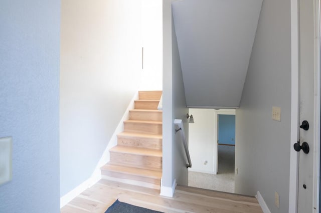 stairway featuring wood finished floors and baseboards