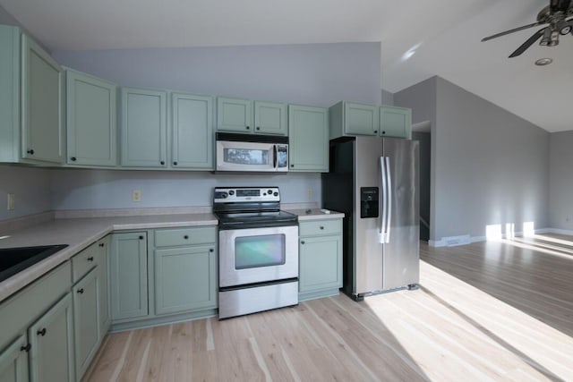 kitchen featuring ceiling fan, light wood-type flooring, light countertops, lofted ceiling, and stainless steel appliances