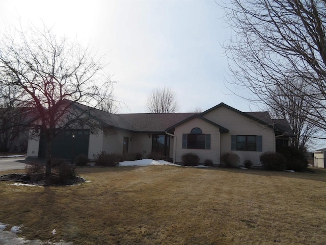 ranch-style house with a front yard, an attached garage, and driveway