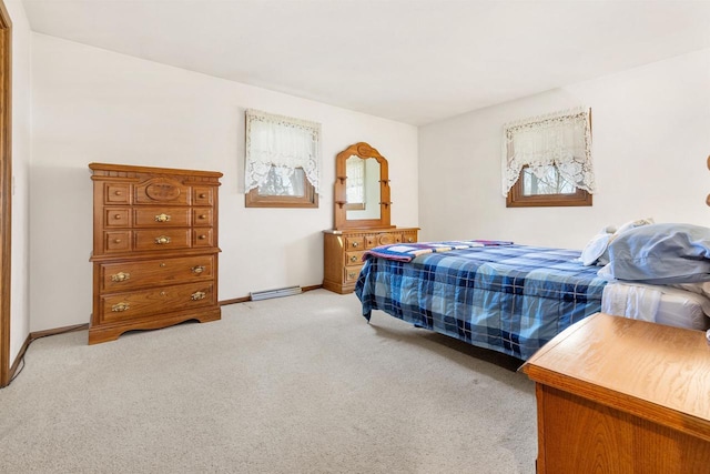 bedroom with light colored carpet and baseboards