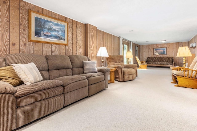 living area featuring carpet flooring and wood walls