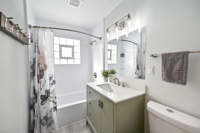 bathroom with vanity, shower / bath combo with shower curtain, toilet, and visible vents