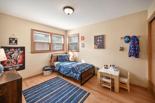 bedroom featuring baseboards and wood finished floors