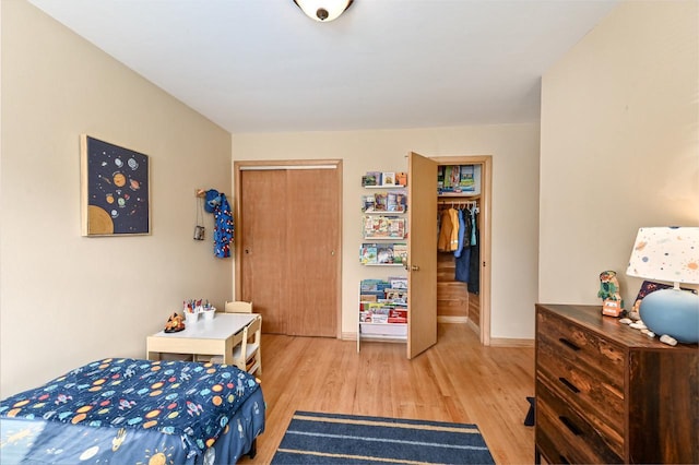 bedroom featuring light wood-type flooring and baseboards