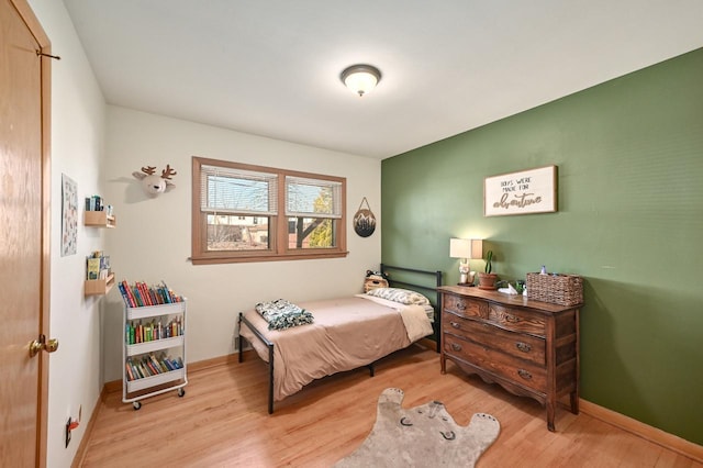 bedroom featuring baseboards and wood finished floors