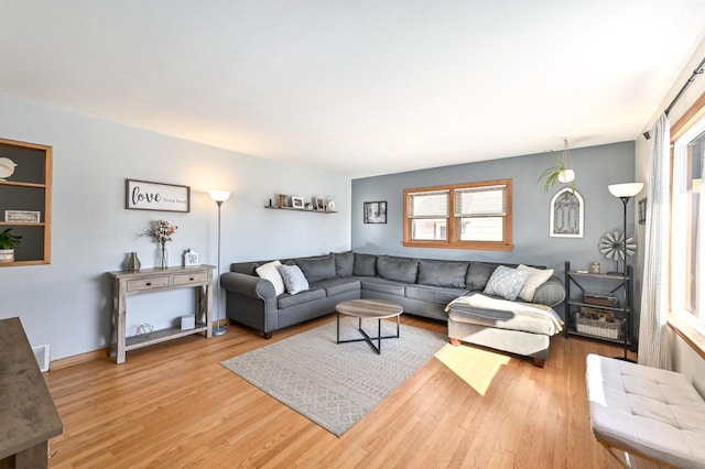 living room with visible vents and wood finished floors