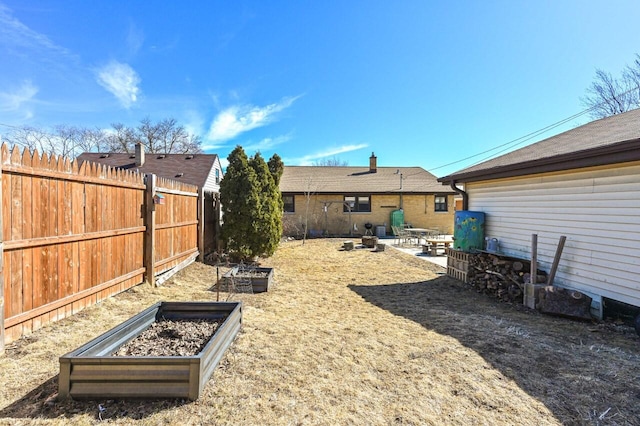 view of yard with a patio, a garden, and fence