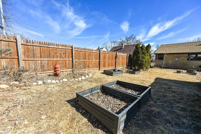 view of yard with fence and a garden