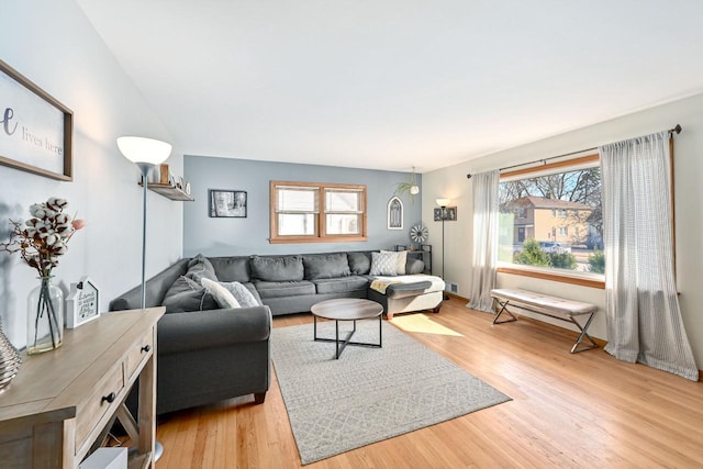 living area with plenty of natural light and light wood-type flooring