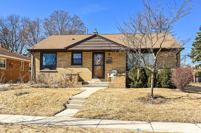 ranch-style house with brick siding and roof with shingles