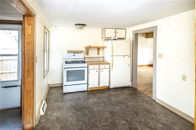 kitchen featuring white appliances, white cabinets, dark floors, light countertops, and baseboards