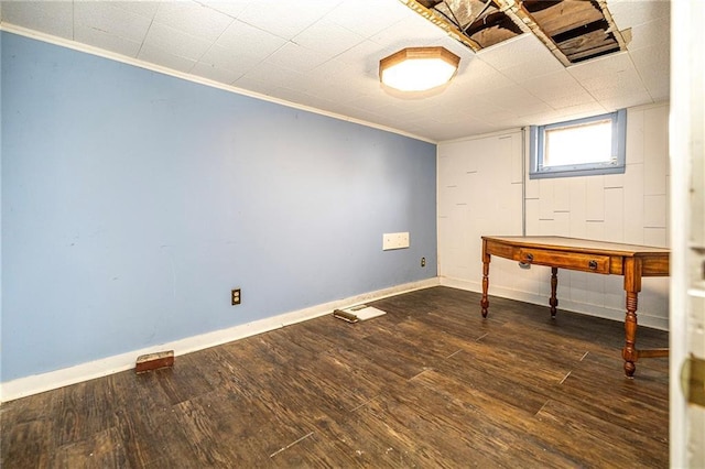 basement with baseboards, wood finished floors, and crown molding