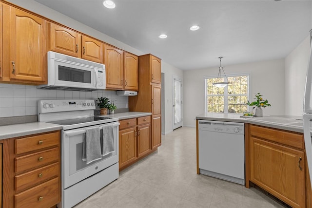 kitchen with white appliances, recessed lighting, light countertops, and tasteful backsplash