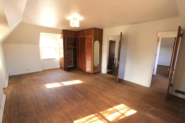 unfurnished bedroom featuring dark wood finished floors, visible vents, and baseboards