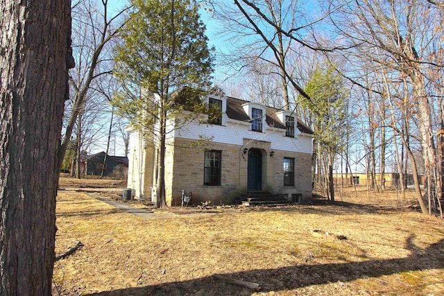 view of front facade featuring stone siding and brick siding