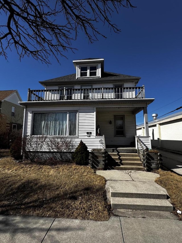 traditional style home with a balcony and covered porch