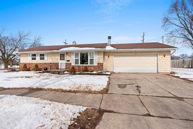 single story home featuring a garage, brick siding, concrete driveway, and fence