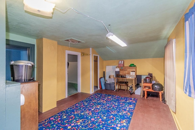 office area with attic access and vaulted ceiling