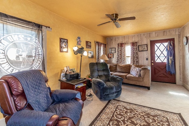 living area featuring a textured ceiling and a ceiling fan