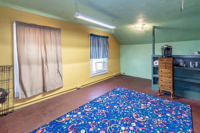 bedroom featuring baseboard heating and vaulted ceiling