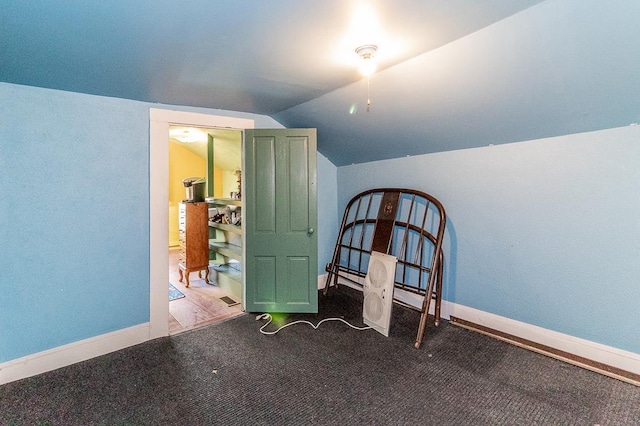 interior space with baseboards and lofted ceiling