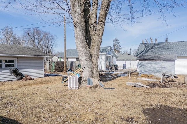 view of yard featuring an outbuilding and fence